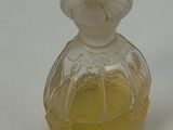 a small glass bottle with a yellow liquid inside of it