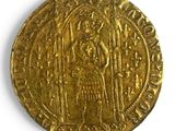 gros plan d'une pièce d'or sur une surface blanche