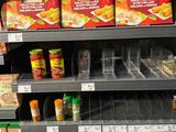 a shelf of food in a store with many items on it