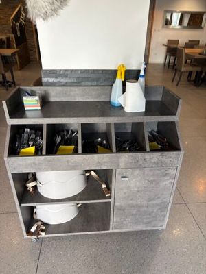 a kitchen with a sink and a counter with a lot of utensils on it