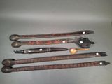 several different types of knives and forks are lined up on a table