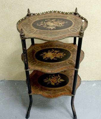 a three tiered table with a decorative design on it