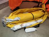 a yellow life jacket on the ground next to a yellow life jacket