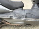 a scooter that is parked on the side of the road