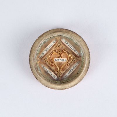 an image of a small gold plate on a white surface