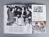 an open book with a picture of a group of people in a room