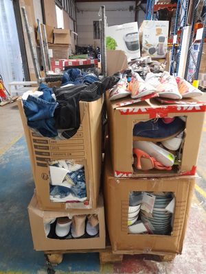 two boxes with shoes on top of them in a warehouse