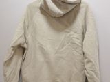 a white sweatshirt hanging on a hanger on a wall