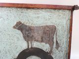 une image représentant une vache peinte sur le mur d'un immeuble
