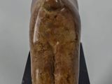 statue of a woman sitting on top of a wooden block