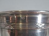 a silver cup that is sitting on a table