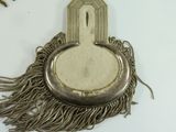 a small metal object with a fringe around it
