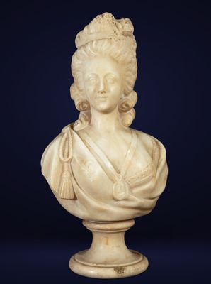 a white marble bust of a woman with a crown on her head