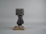 an image of a statue of a woman holding a box on her head