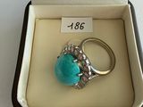 an image of a ring in a box with a turquoise stone