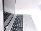 a silver laptop with a black keyboard on a white surface
