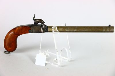 an old gun with a wooden handle on a white surface