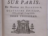 an open book with a picture of a building in the background