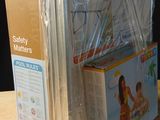 a box of baby diapers sitting on a table next to a box of diapers