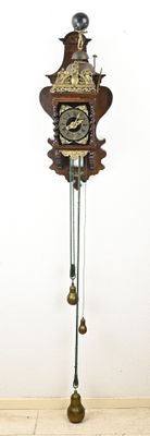 a clock that is on a stand on the floor