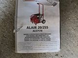 an advertisement for a lawn mower on the ground with a sticker attached to it