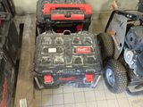 two lawn mowers and two lawn mowers on the floor