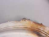 a silver plate with a small house on top of it