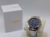 the watch is sitting on the stand next to the box