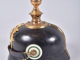a black helmet with a green and gold decoration on it