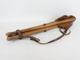 an old pair of wooden sticks sitting on top of a white surface