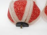 pair of red and white glittered lamps on a white surface
