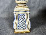 a small blue and white vase sitting on top of a table