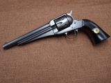 a close up of a revolver on a brown background