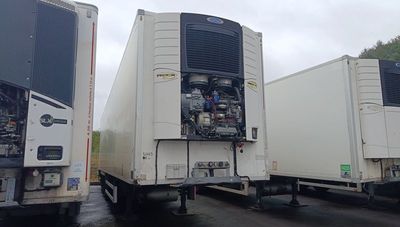 two trucks that are parked in a parking lot