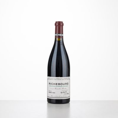 a bottle of red wine sitting on top of a table