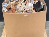 a cardboard box full of shoes and other items on a pallet
