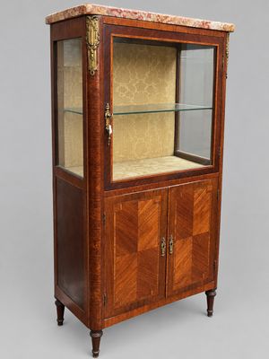 a wooden display cabinet with marble top and glass doors