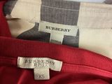 a close up of a red shirt with a label on it