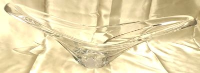 un vase en verre transparent posé sur une nappe blanche, sur une table