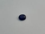 a small black stone sitting on top of a white table