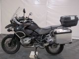 bmw motorcycle parked in a garage with luggage on the back of it