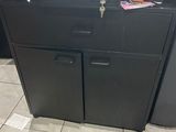 a black cabinet with a laptop on top of it