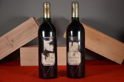 two bottles of wine sitting next to each other on a table