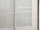 an open book on a white table with a black and white picture