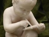 a small statue of a boy with a toothbrush in his hand
