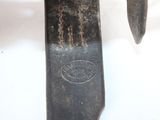 a close up of a knife on a white surface