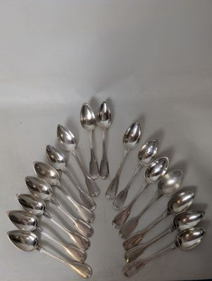 a lot of spoons arranged in a circle on the table