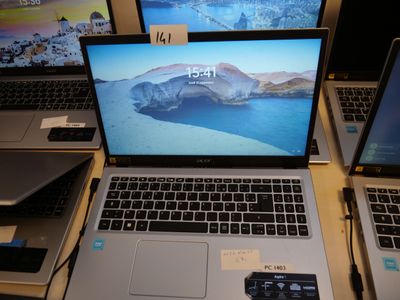several laptops are sitting on a table in front of each other