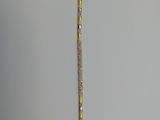 an image of a gold and diamond bracelet on a gray background