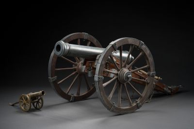 a cannon sitting on top of a wooden wheel